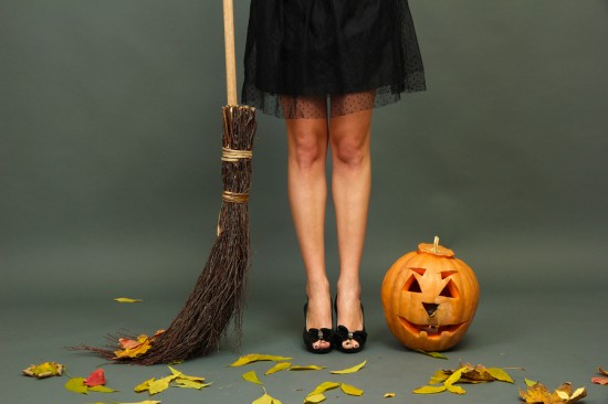 Halloween background with pretty female legs