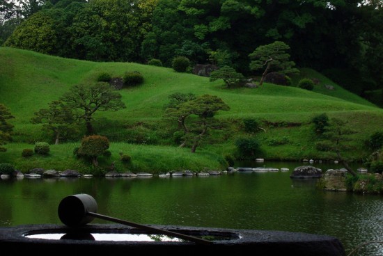 Zen garden with water scoop on well