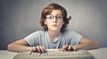 Child Typing On A Computer Key